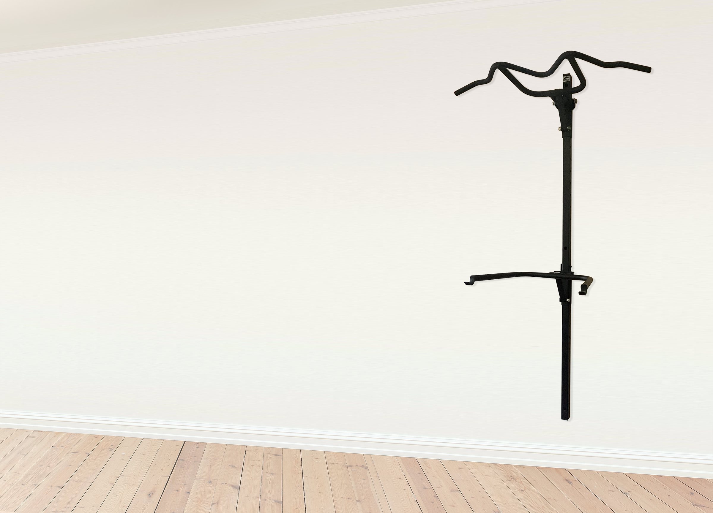 A MITZ foldable pull-up bar mounted on a white wall of an empty room